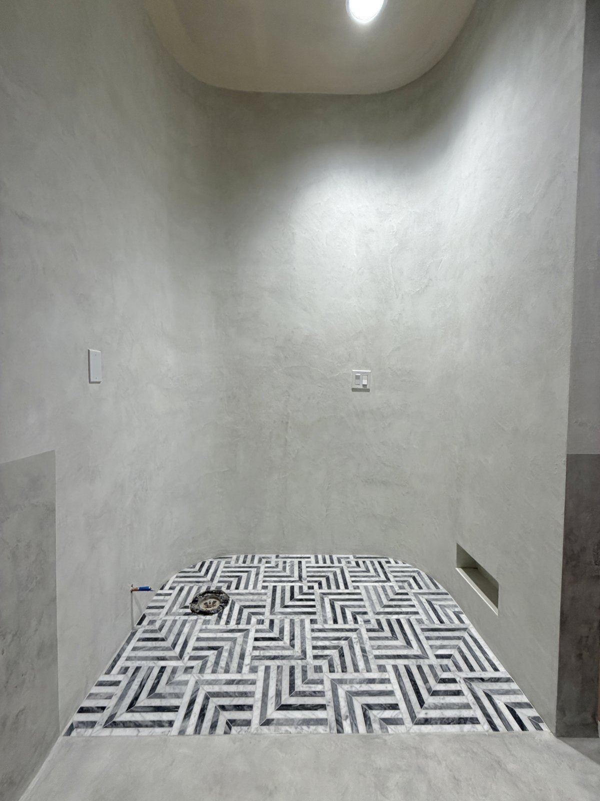 Micro cement shower, marble mosaic floor